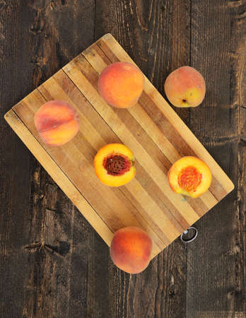 Fresh peaches on wooden tableの写真素材