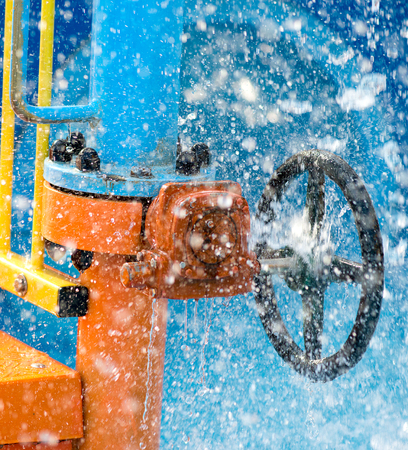 blue wheel valve with pipe and wather flooding aroundの写真素材