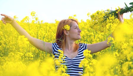 portrait of a beautiful girl in the colza field