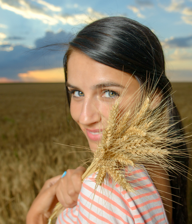 Natural beauty. Beautiful girl in a wheat fieldの写真素材