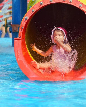 outdoor portrait of young smiling child having fun in aquaparkの写真素材