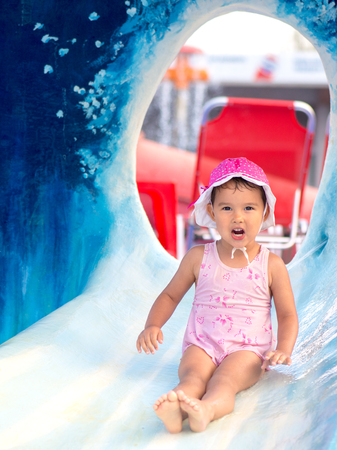 outdoor portrait of young smiling child having fun in aquaparkの写真素材