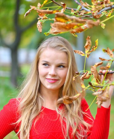 Portrait of beautiful young woman outdoors in autumnの写真素材