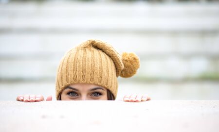 Portrait of a beautiful woman who is hiding and looks like she is playingの写真素材
