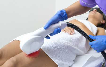 Woman getting laser treatment in a beauty salon, close upの写真素材