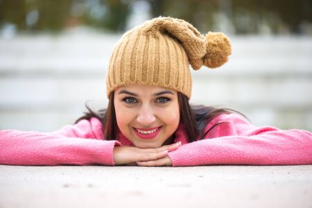 Happy beautiful young woman in warm soft clothes outdoor in a winter dayの写真素材