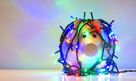 Piggy bank wrapped in Christmas string lightsの写真素材