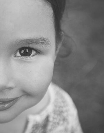 copy space and half face of little girl in black and whiteの写真素材
