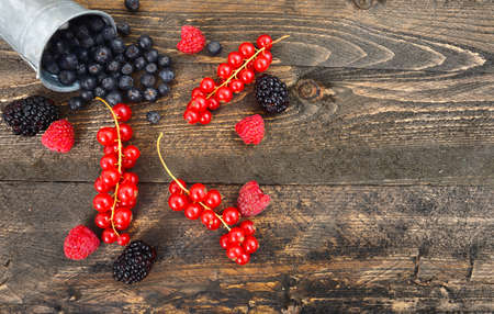 Blueberry, red currant and blackberry mix on wooden backgroundの写真素材