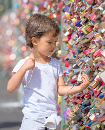little girl looking at the locks from de Koln Bridge, Germanyの写真素材