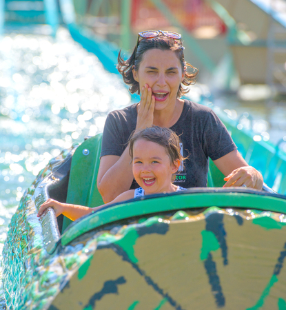 Mother and her daughter having fun in waterparkの写真素材