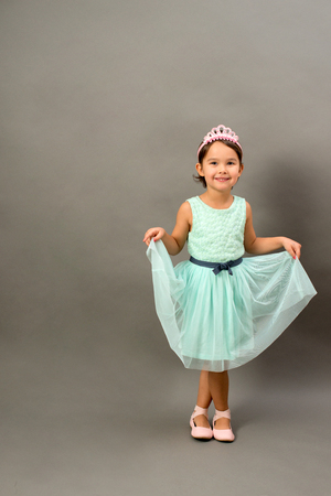 Full length of little fashion girl in studioの写真素材