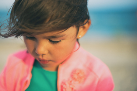 Portrait of a little girl on the beach. Focus on eyeの写真素材