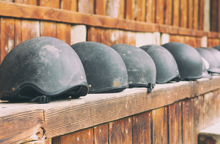 Horse helmets in a line waiting to be usedの写真素材