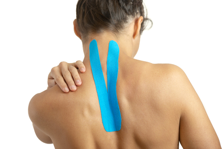 Female back with physio tape on white backgroundの写真素材