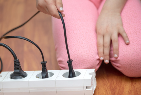 Little child playing with plug