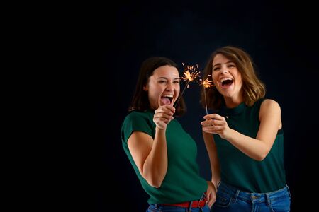 Happy women holding sparklers.