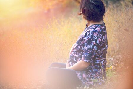 portrait of beautiful pregnant woman in natureの写真素材