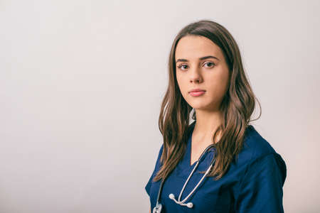 healthcare and medicine concept - Portrait of a woman doctor with stethoscope isolated on whiteの写真素材