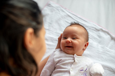 newborn baby in motherâ€™s arms, top view