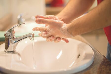 Washing hands rubbing with soap man for corona virus prevention, hygiene to stop spreading coronavirus.の写真素材