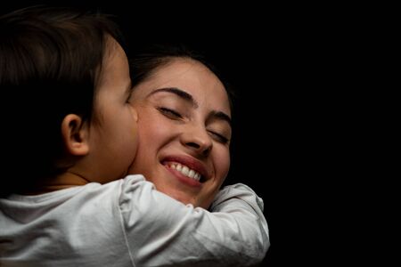 little girl kissing her motherの写真素材