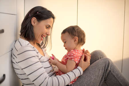 Happy loving family. mother and child girl playing, kissing and huggingの写真素材