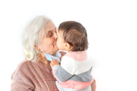 Granddaughter kissing her grandmother after coming out of covid quarantine