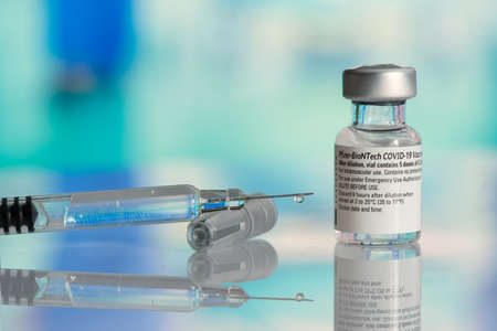 Galati, Romania - February 16, 2021: Pfizer Biontech vaccine and syringe to protect against coronavirus COVID-19 disease.のeditorial素材