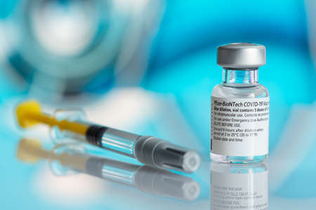 Galati, Romania - February 16, 2021: Pfizer Biontech vaccine and syringe to protect against coronavirus COVID-19 disease.のeditorial素材