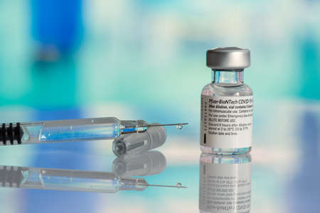 Galati, Romania - February 16, 2021: Pfizer Biontech vaccine and syringe to protect against coronavirus COVID-19 disease.のeditorial素材