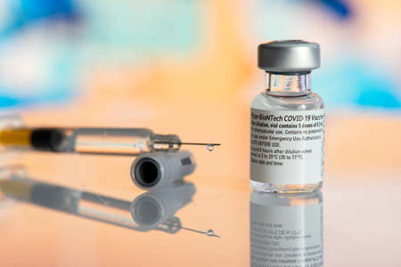 Galati, Romania - February 16, 2021: Pfizer Biontech vaccine and syringe to protect against coronavirus COVID-19 disease.のeditorial素材