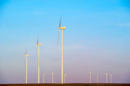 Windmills for electric power production at sunsetの写真素材