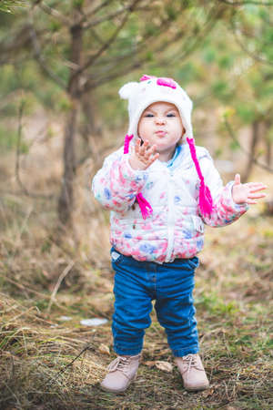 Portrait of little toddler girl having fun outdoors in cold weather at mountainsの写真素材