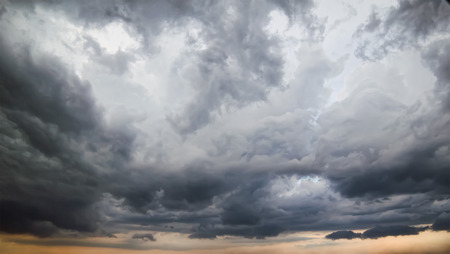 Dark stormy sky with light breaks in the clouds.