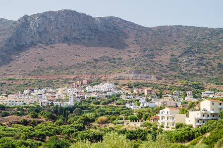 Piskopiano village in sunny summer day with the plumb cliff in the background, Crete, Grece.の写真素材