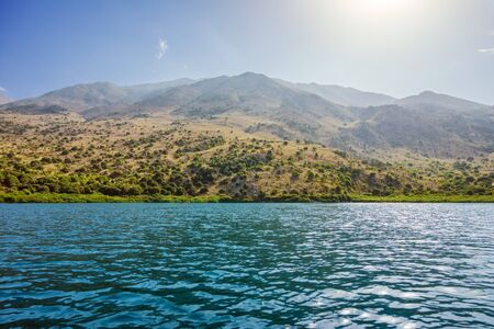 Kurna lake with mountain landscape in the background, Crete, Greece.の写真素材