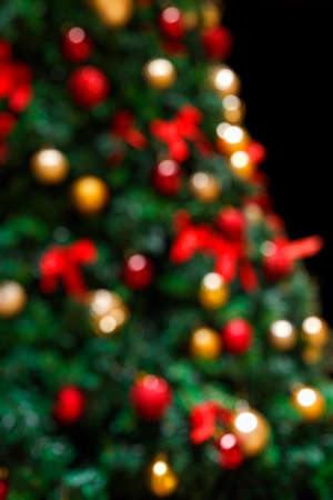 Decorated Christmas Tree Defocussed Bokeh Background. Winter holidays vertical backdrop.の写真素材