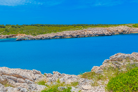 Menorca Island Rocky Coast with Clean Blue Water of the Mediterranean Sea, Spain.の写真素材