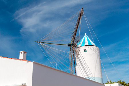 Traditional Old White Windmill against Blue Sky at Menorca Island, Spain.の写真素材