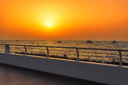 The Palm Jumeirah Crescent Rd Seafront Orange Sunset, Dubai, UAE. Setting Sun Travel Background.の写真素材