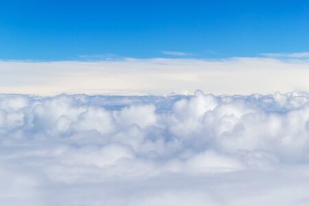 White Fluffy Clouds with Blue Sky Above. White Clouds from Airplane.の写真素材