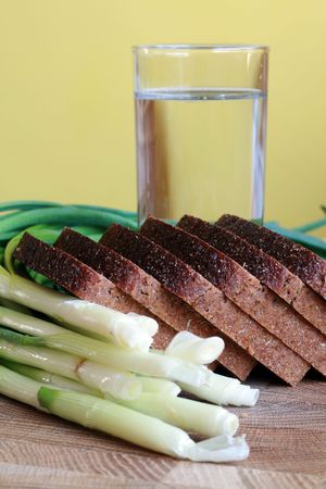 Black bread, onion and glass of waterの写真素材