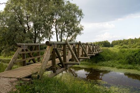 New wooden bridge over river 