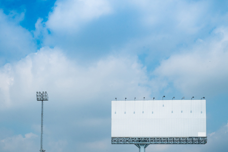 White bilboard with sports lighting,blue sky background.の写真素材