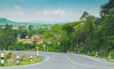 Sharp curve on the hill with asphalt road,blue sky background.の写真素材
