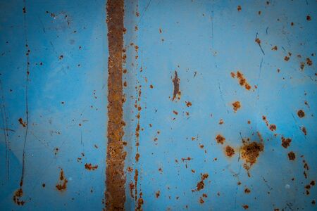Rusted blue painted metal wall. Rusty metal background with streaks of rust