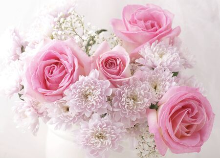 Pink and white flowers in a vase の写真素材