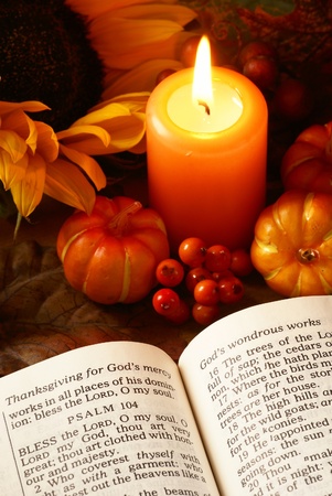 Open Bible, candle, and autumn decorationsの写真素材
