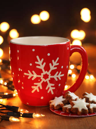 Mug with hot drink and Christmas cookiesの写真素材
